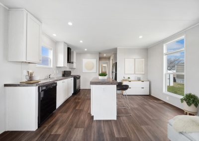 Model kitchen with island and black appliances at Cedar Ridge Manufactured Homes in Wichita Kansas
