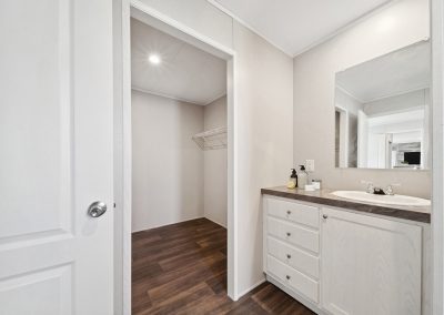 Model bathroom vanity and walk in closet at Cedar Ridge Manufactured Homes in Wichita Kansas
