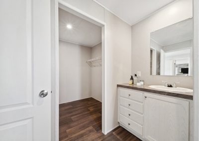 Model bathroom vanity and walk-in closet at Cedar Ridge Manufactured Homes in Wichita, Kansas