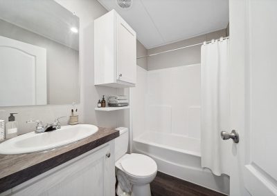 Model bathroom with white vanity at Cedar Ridge Manufactured Homes in Wichita Kansas