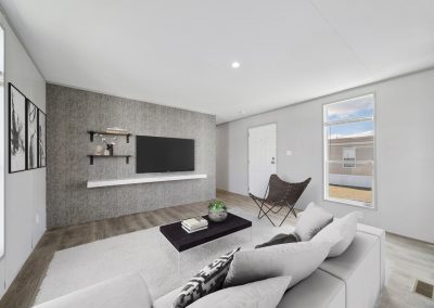 Model living room with patterned accent wall at Cedar Ridge Manufactured Homes in Wichita Kansas