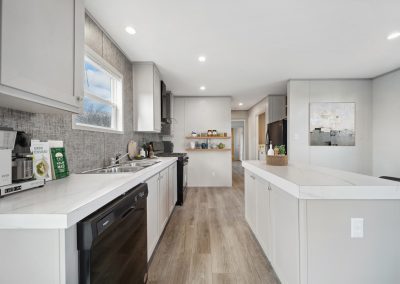Model kitchen with black appliances at Cedar Ridge Manufactured Homes in Wichita Kansas
