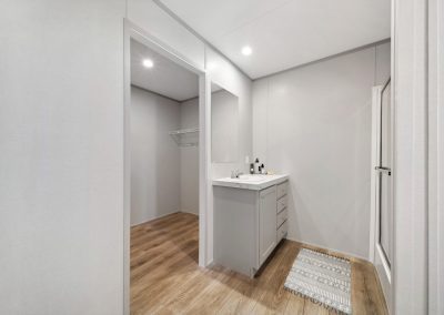 Model bathroom with vanity and walk in closet at Cedar Ridge Manufactured Homes in Wichita Kansas