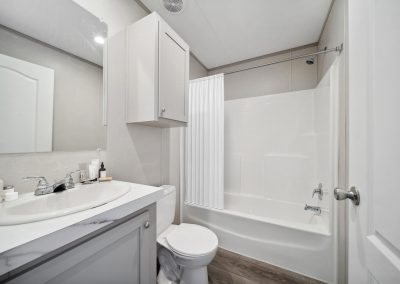 Model bathroom with bath tub and shower combo at Cedar Ridge Manufactured Homes in Wichita, Kansas