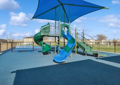 Community playground with sun cover at Cedar Ridge Manufactured Homes in Wichita Kansas